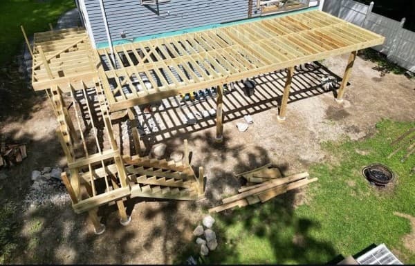 Pressure-treated deck framing and stair stringers going up