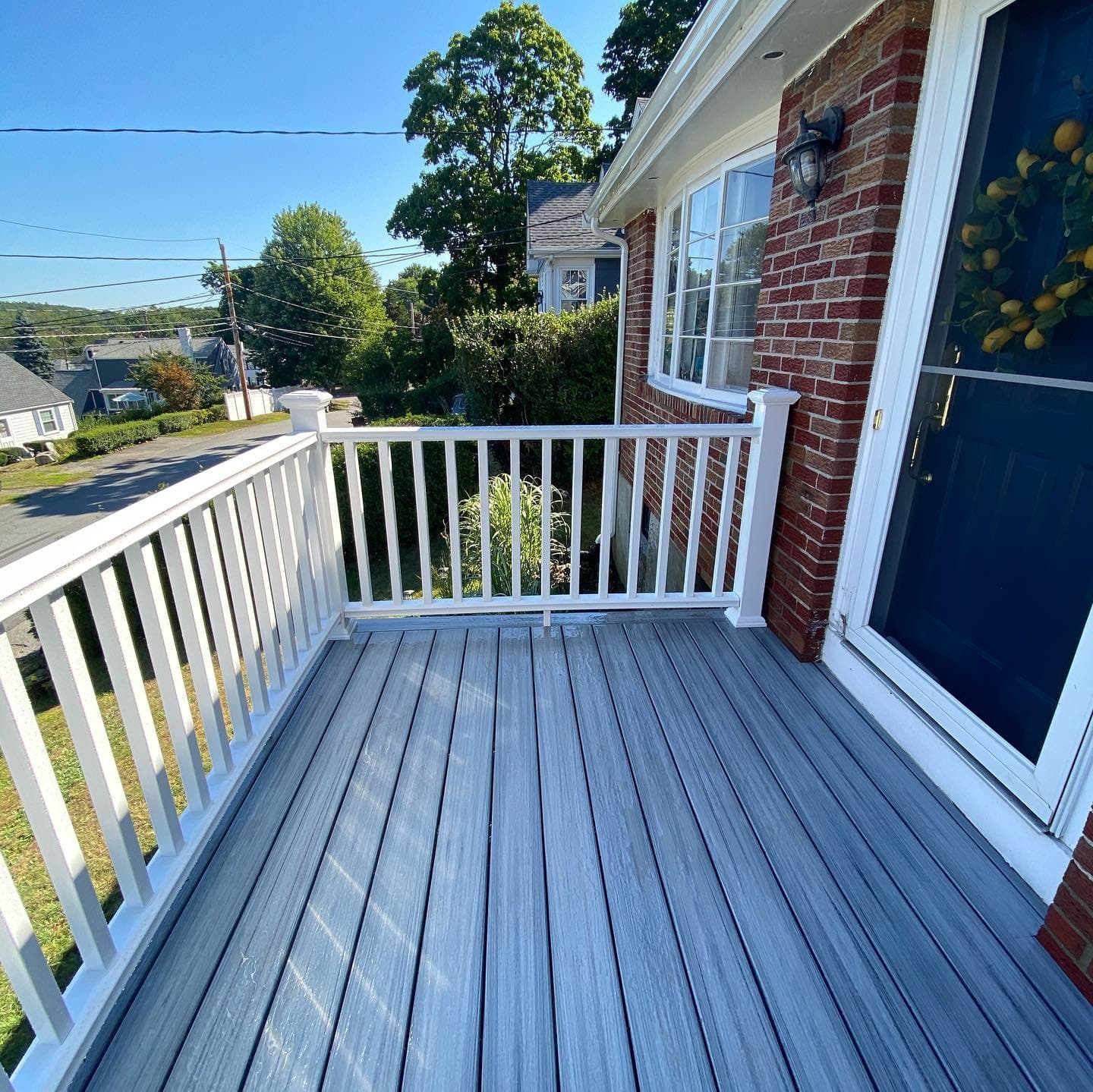 Front porch deck with blue-grey composite and white rail