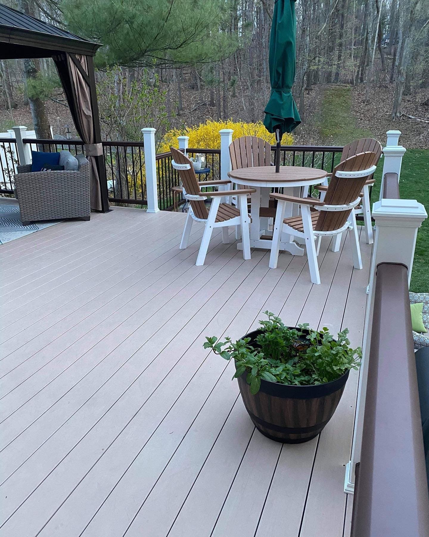 Light grey composite deck with a dining set