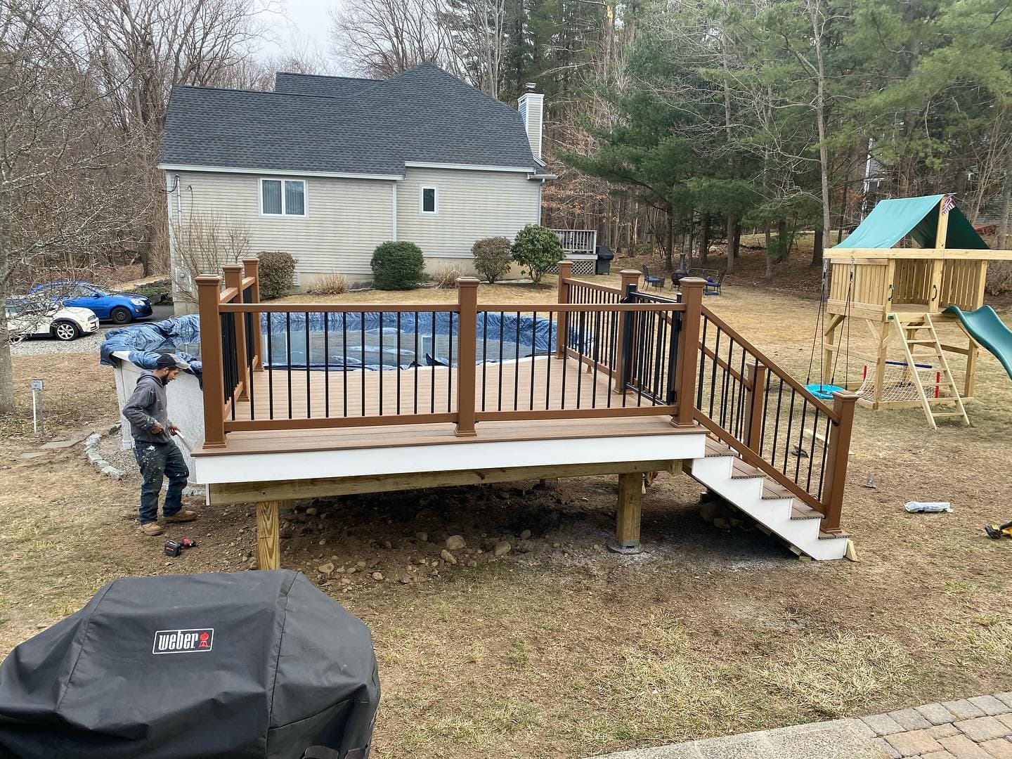 Deck with railings built around an above-ground pool