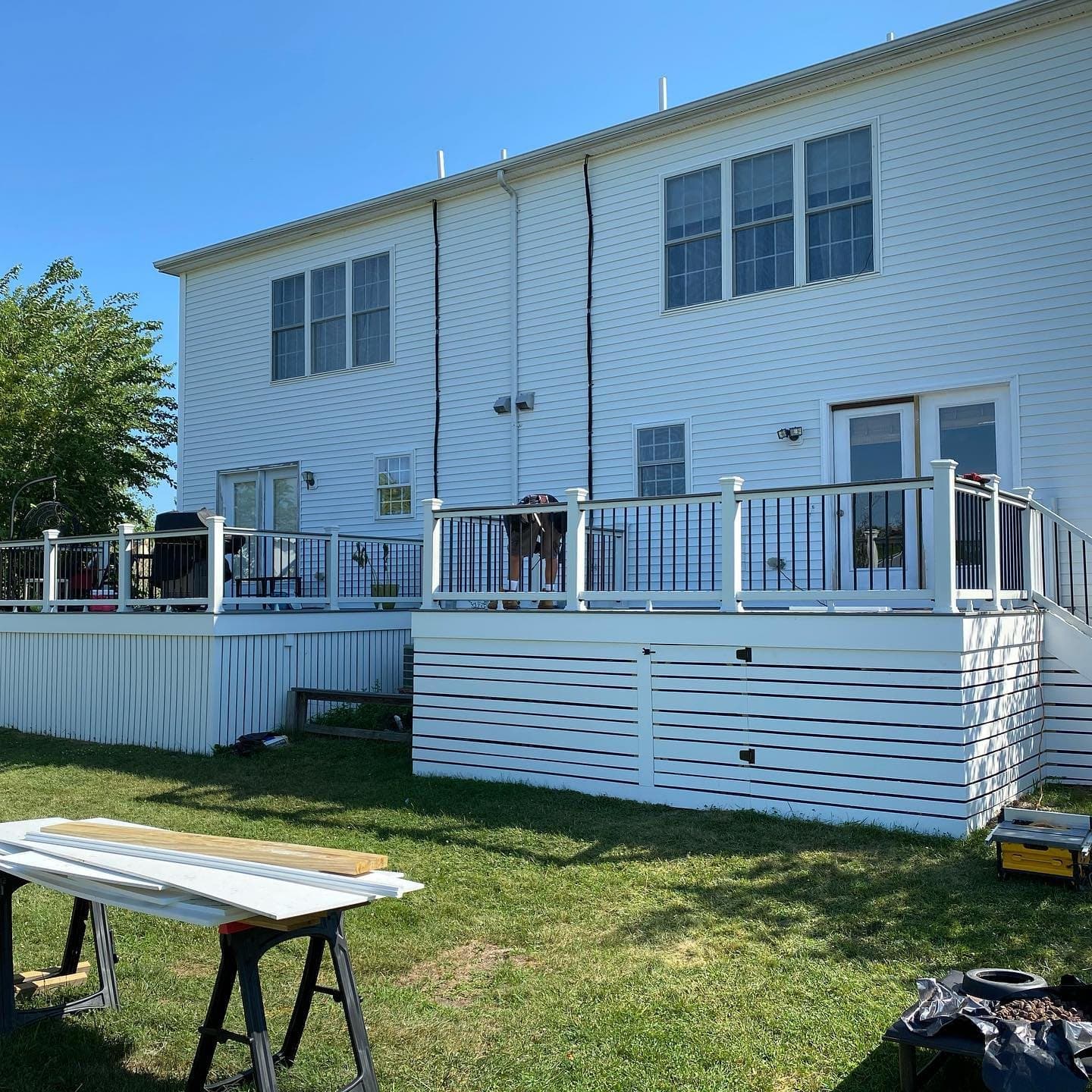 Raised deck with white railings and white PVC skirting