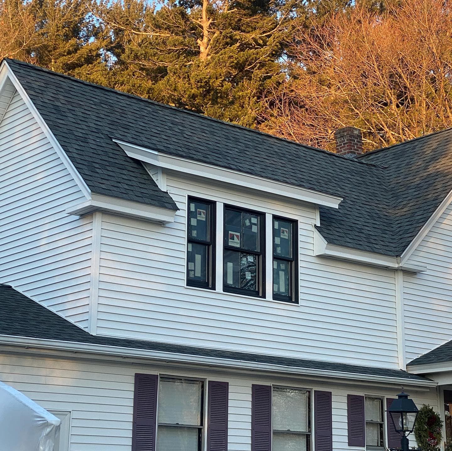 Shed dormer addition with three new windows, tied into the existing roofline and siding