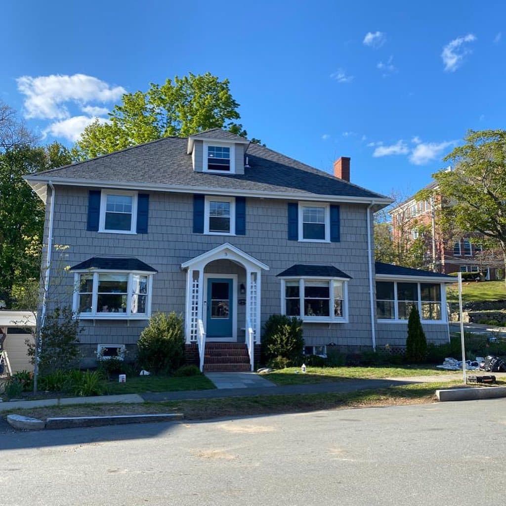 Grey colonial with new siding and white trim