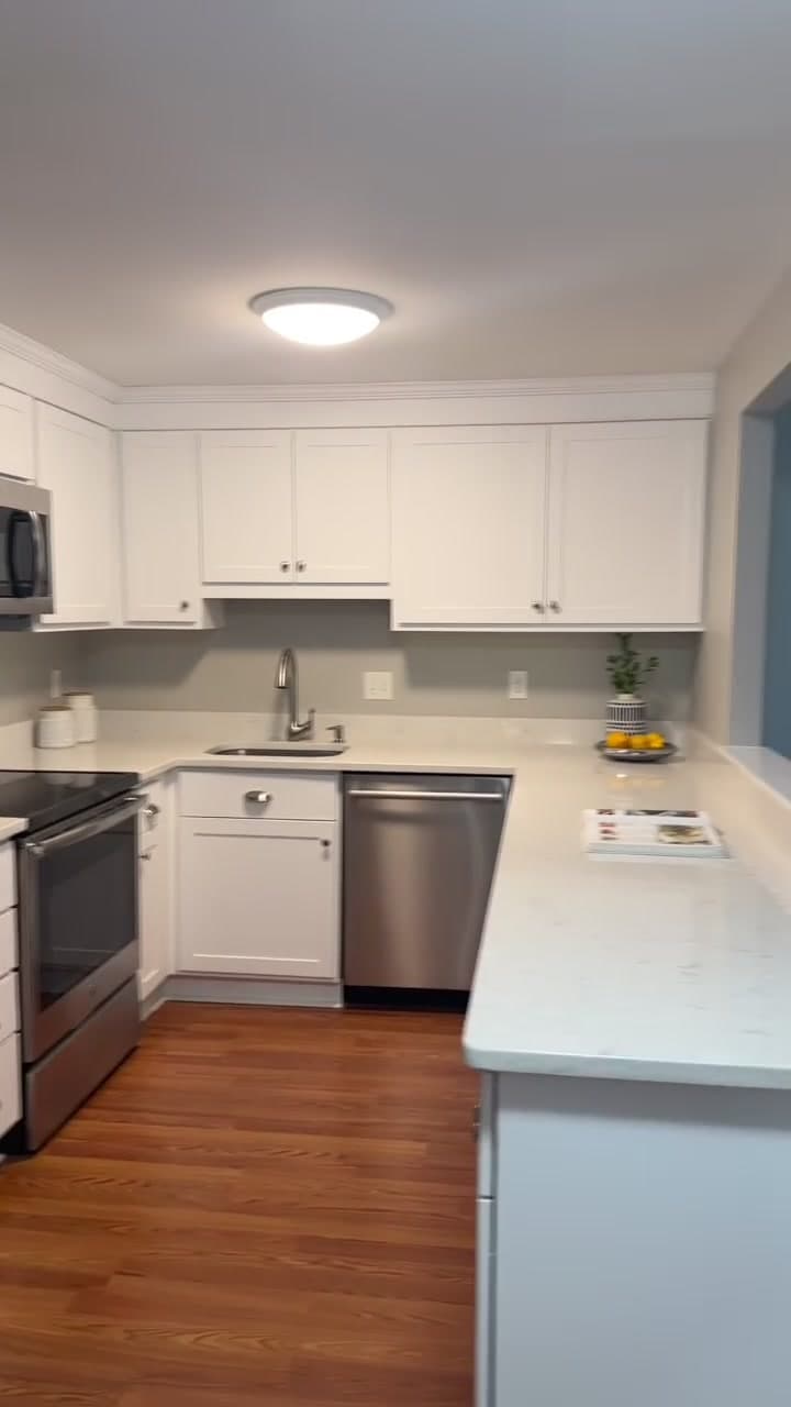 Renovated kitchen with white cabinets and quartz counters