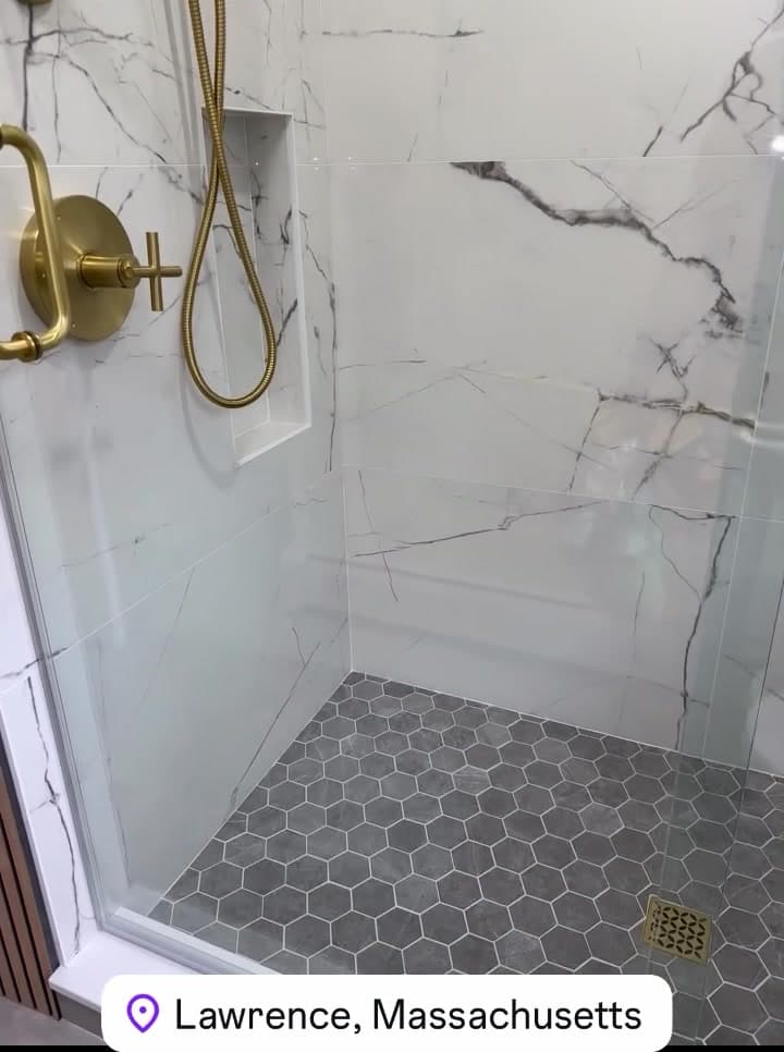 Shower with hex tile floor and a recessed niche