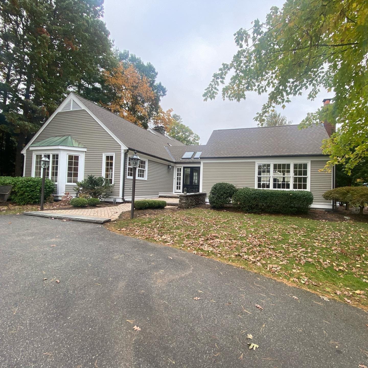 Grey ranch home with fresh siding and trim