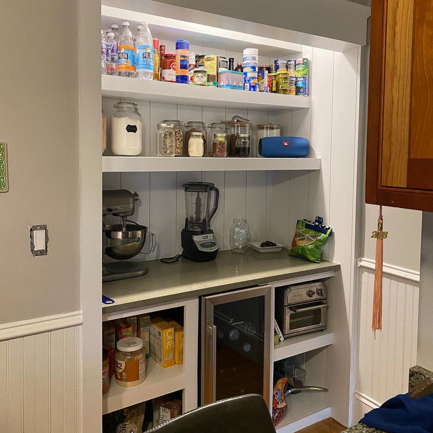 Built-in pantry with open shelves and beadboard