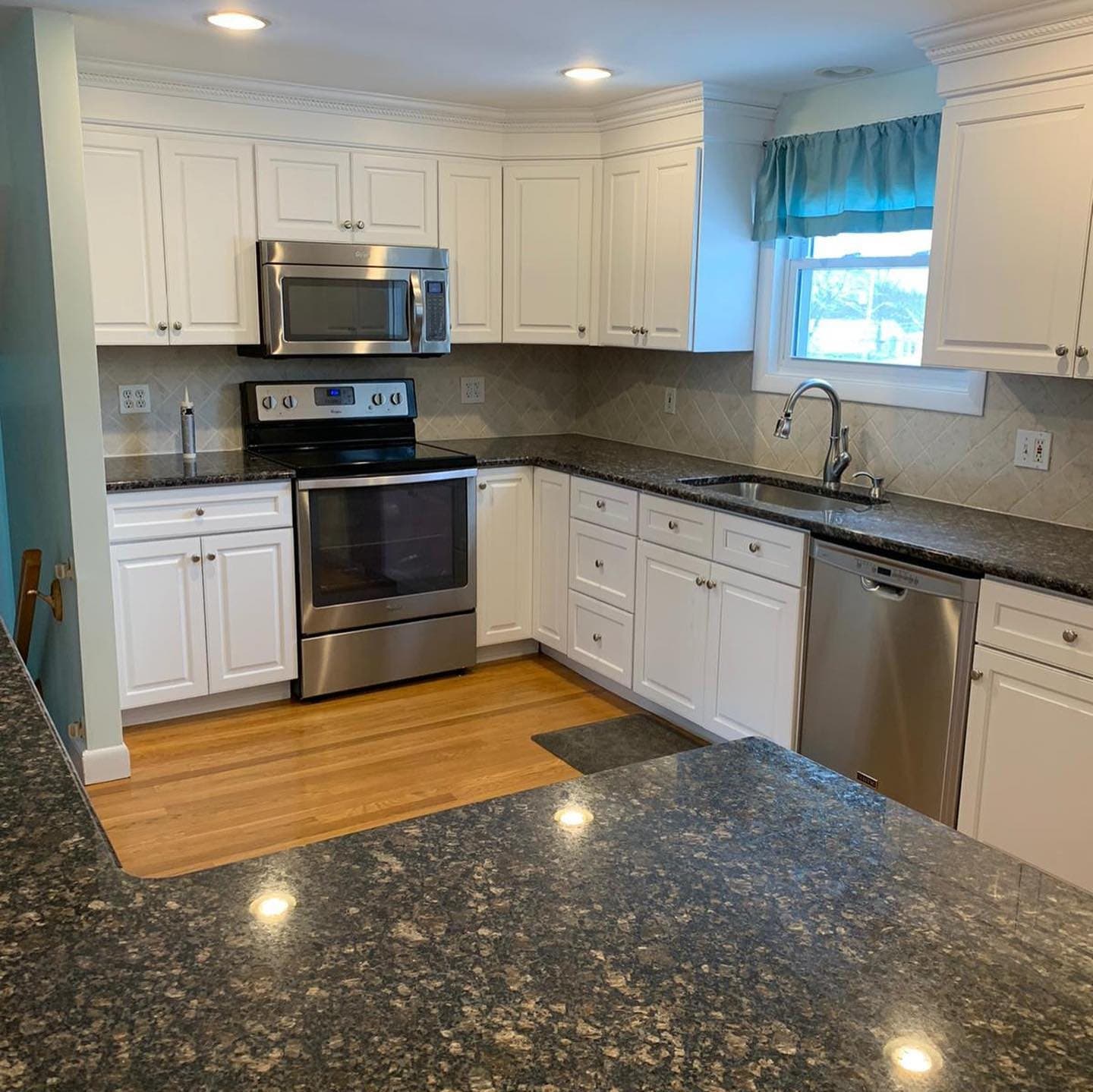 White cabinets with dark granite counters