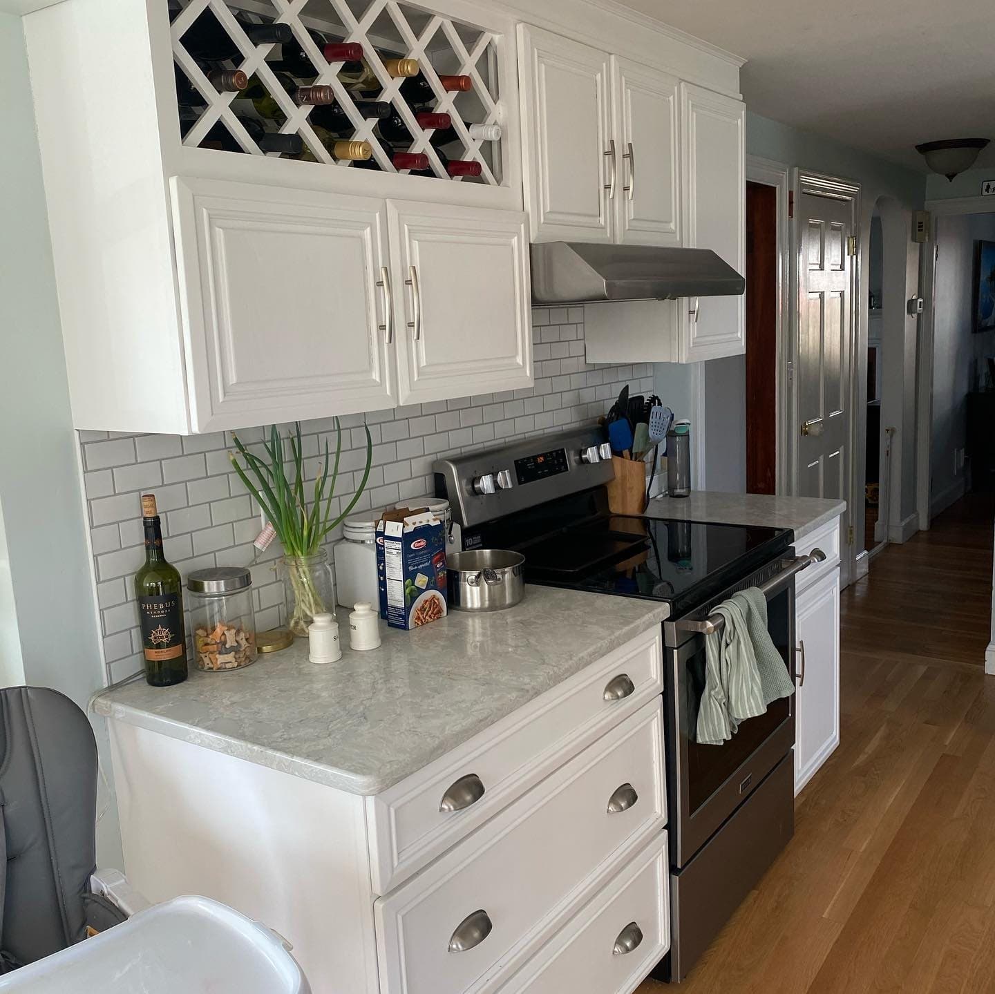 White cabinets with a wine rack above